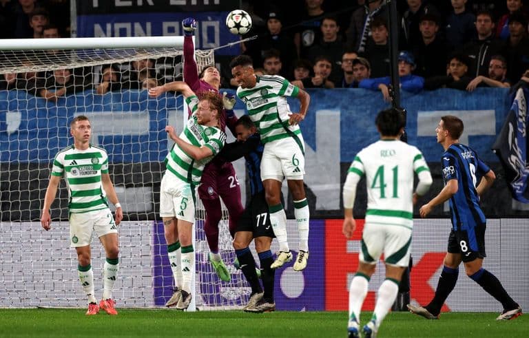 Auston Trusty jumps to win a header for Celtic